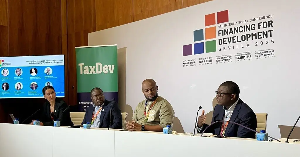 Panel of four speakers on stage at the Fourth International Conference on Financing for Development in Seville