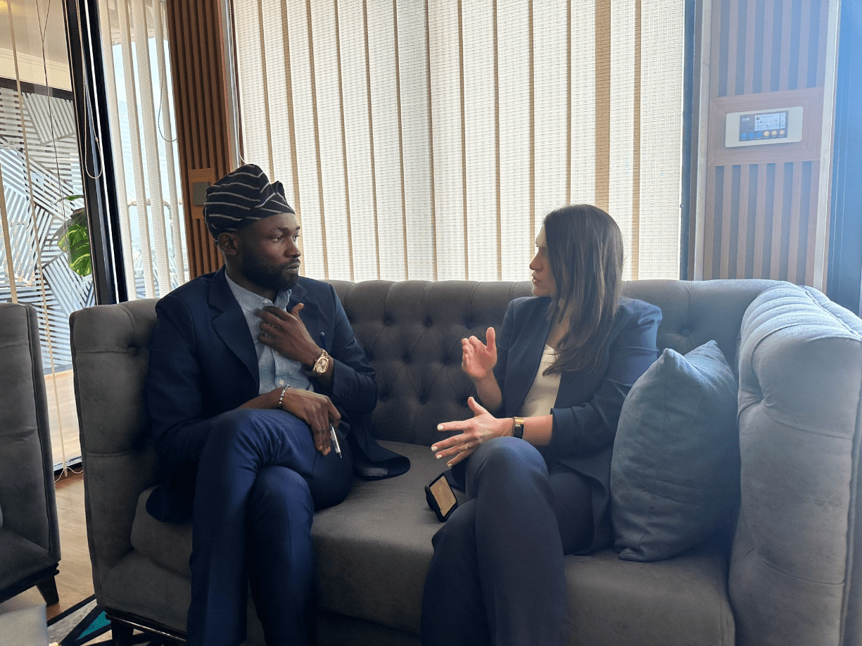 Deux personnes en conversation sur un canapé lors de la réunion des parties prenantes à Abuja