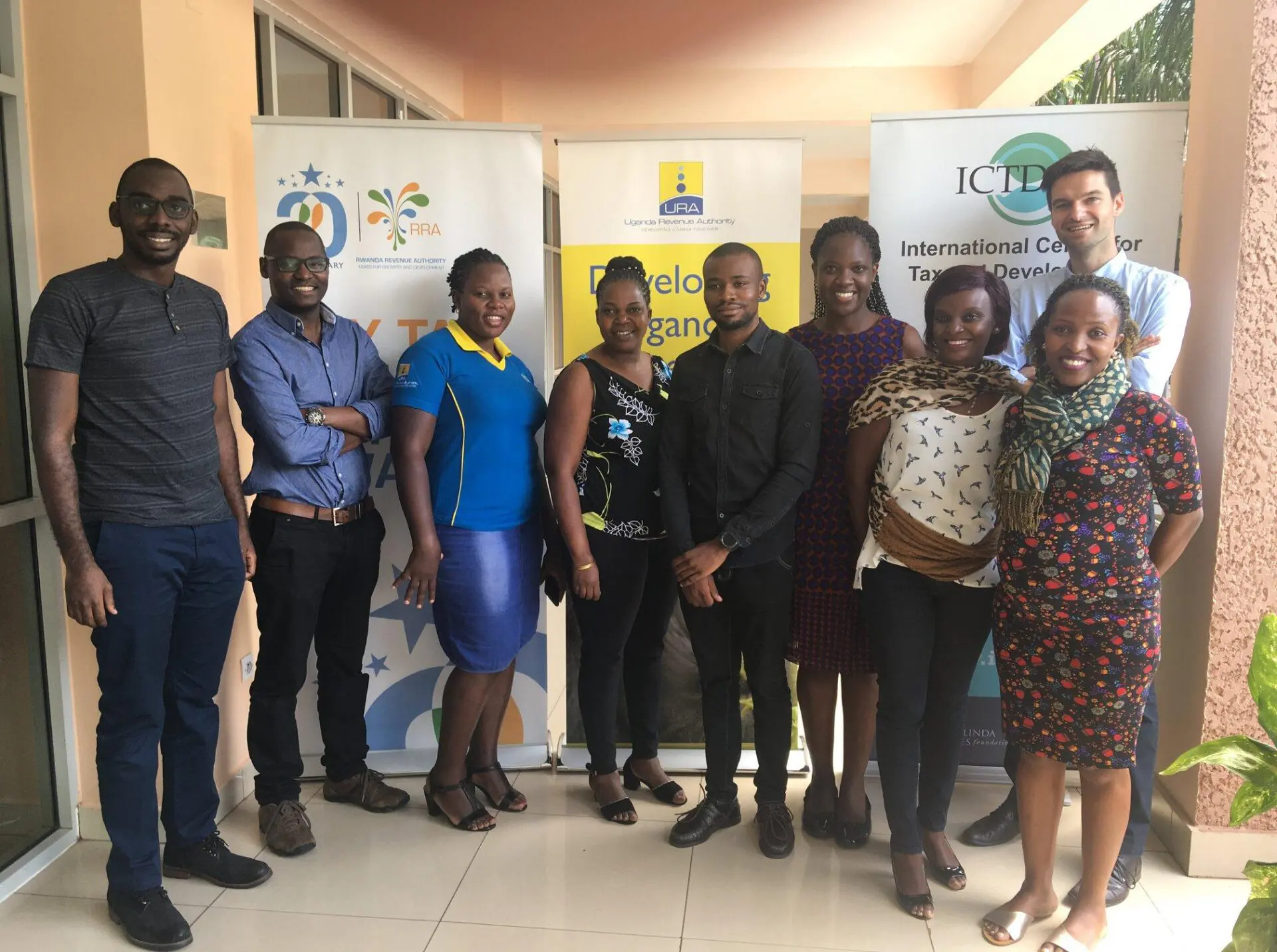 Group photo of ICTD and revenue authority staff at a tax research workshop, in front of ICTD, Uganda Revenue Authority and Rwanda Revenue Authority banners