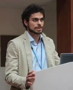 Giovanni Occhiali speaking at a lectern