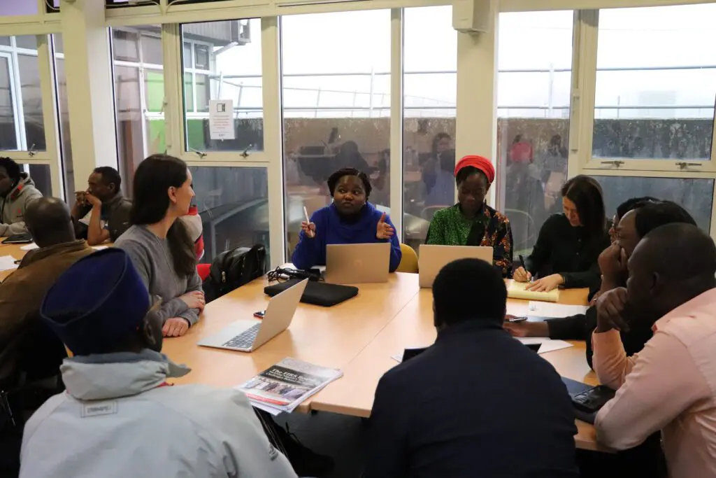 Participants in a breakout group discussion around a table