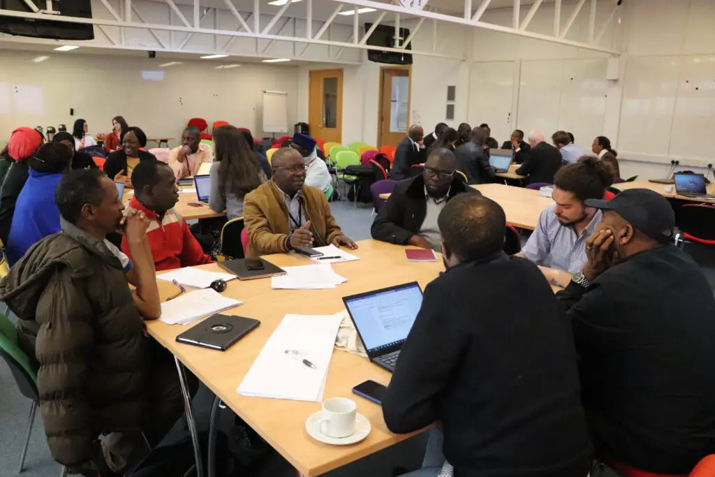 Participants working at tables during a workshop session