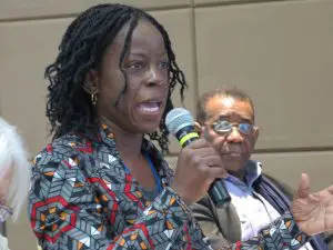 Jalia Kangave speaking into a microphone at the launch of the Bogota Declaration