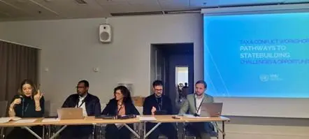 Panel discussion with five speakers including Ashley Jackson (first one from the left) and Max Gallien (first one from the right)