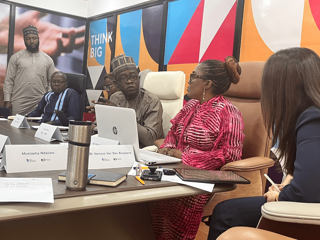 Participants en discussion autour d'une table lors de la réunion des parties prenantes à Abuja