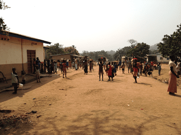 Schoolchildren carrying local materials for a school building project in Koinadugu district, Sierra Leone